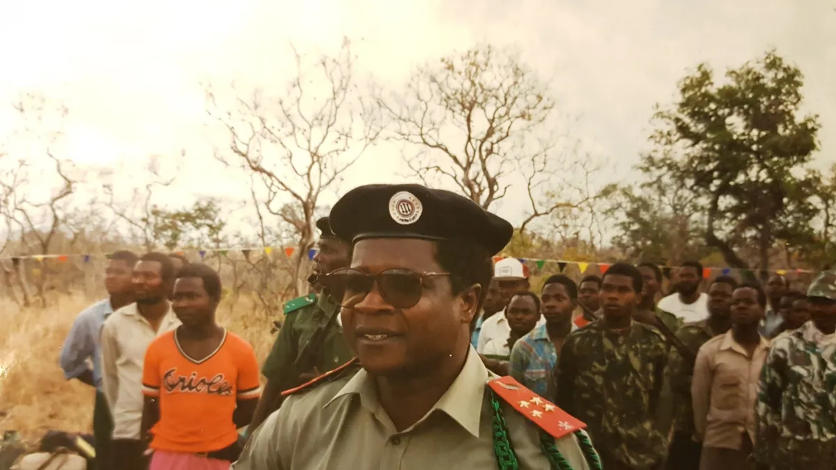 Afonso Dhlakama, Renamo's leader, in a beret and dark glasses in front of a crowd of supporters and fighters at his Maringue base, 1993